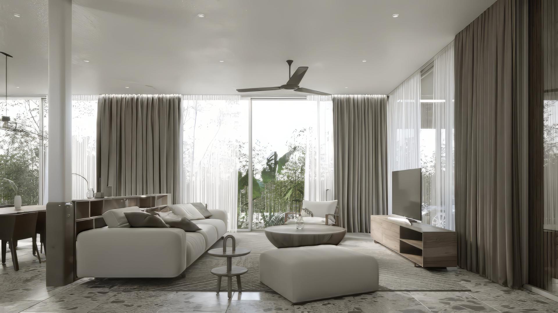 A living room with large windows that feature blackout curtains layered with sheer curtains.