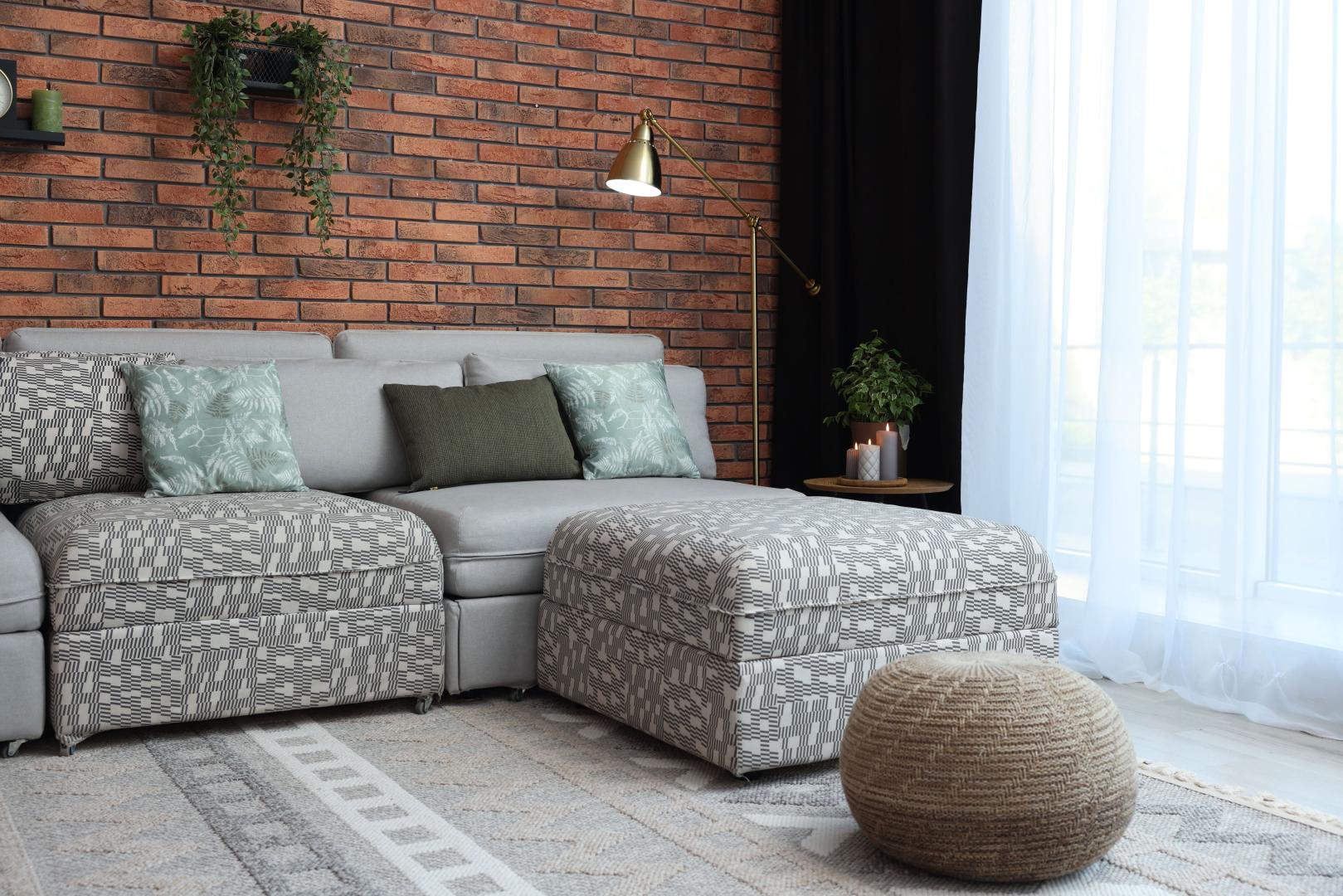 A living room with a gray patterned couch.
