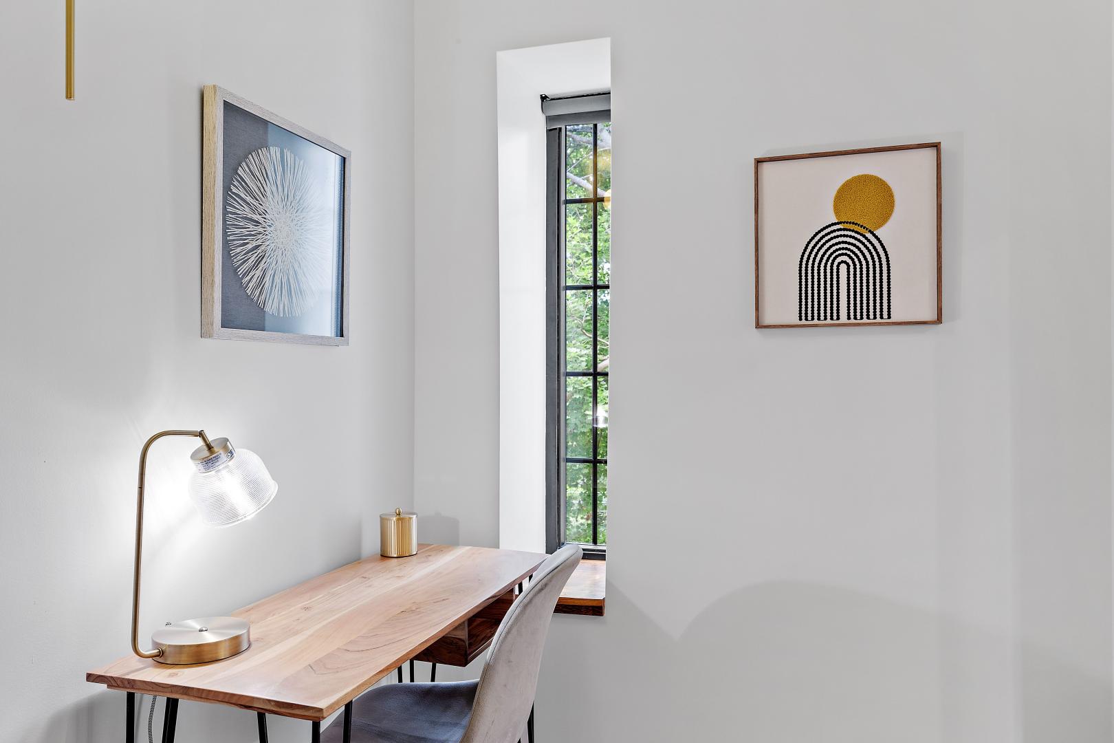 A small table next to a long, thin window.