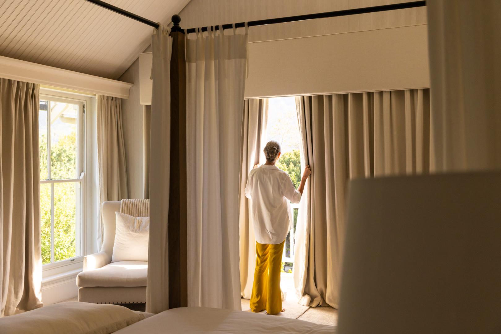 A light bedroom with thick blackout curtains.