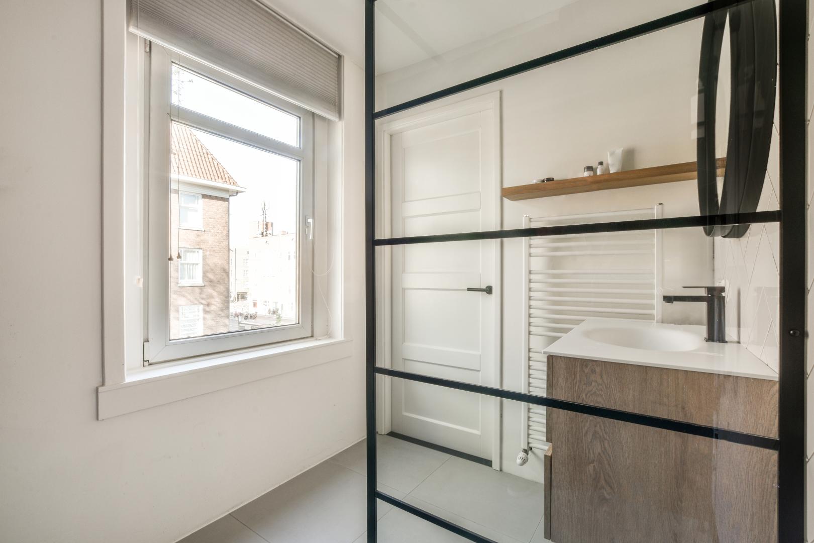 A bathroom with a small window.