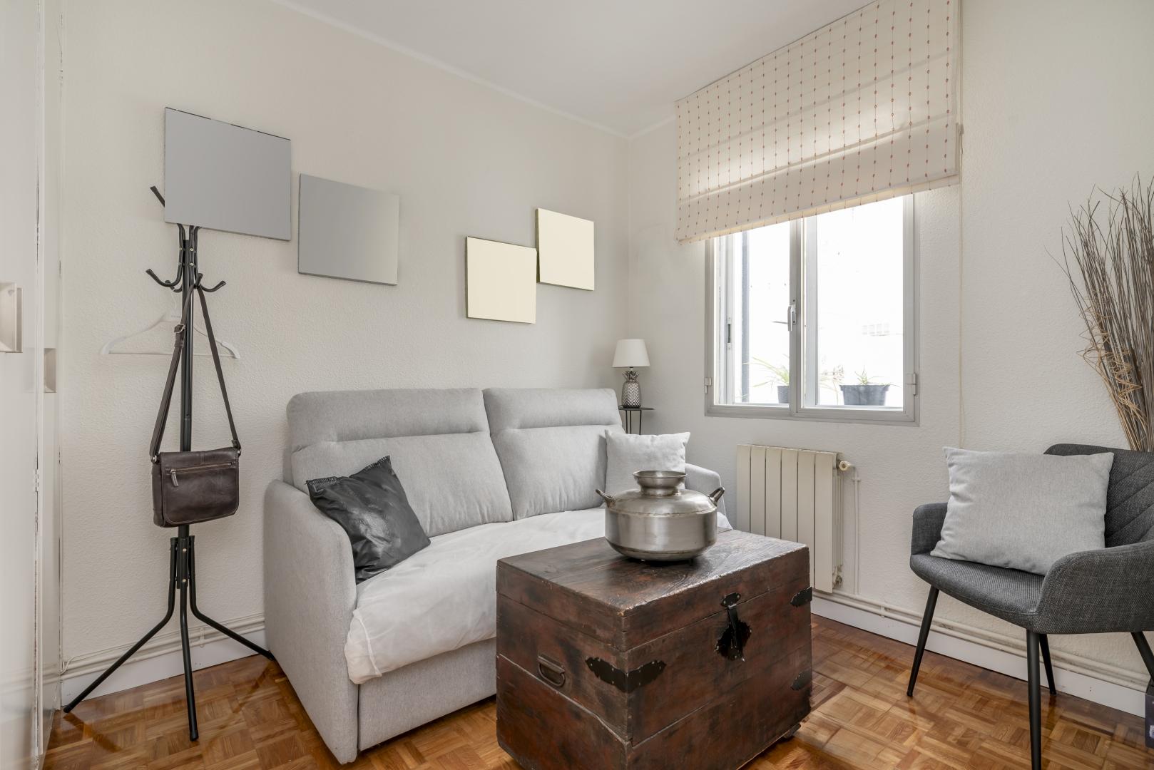 A small living room with light shades.
