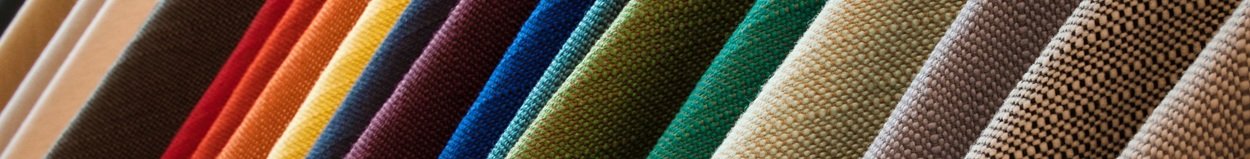 A line of hanging textured fabrics of different colors and shades