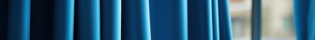 Elegant blue drapes surrounding a window.