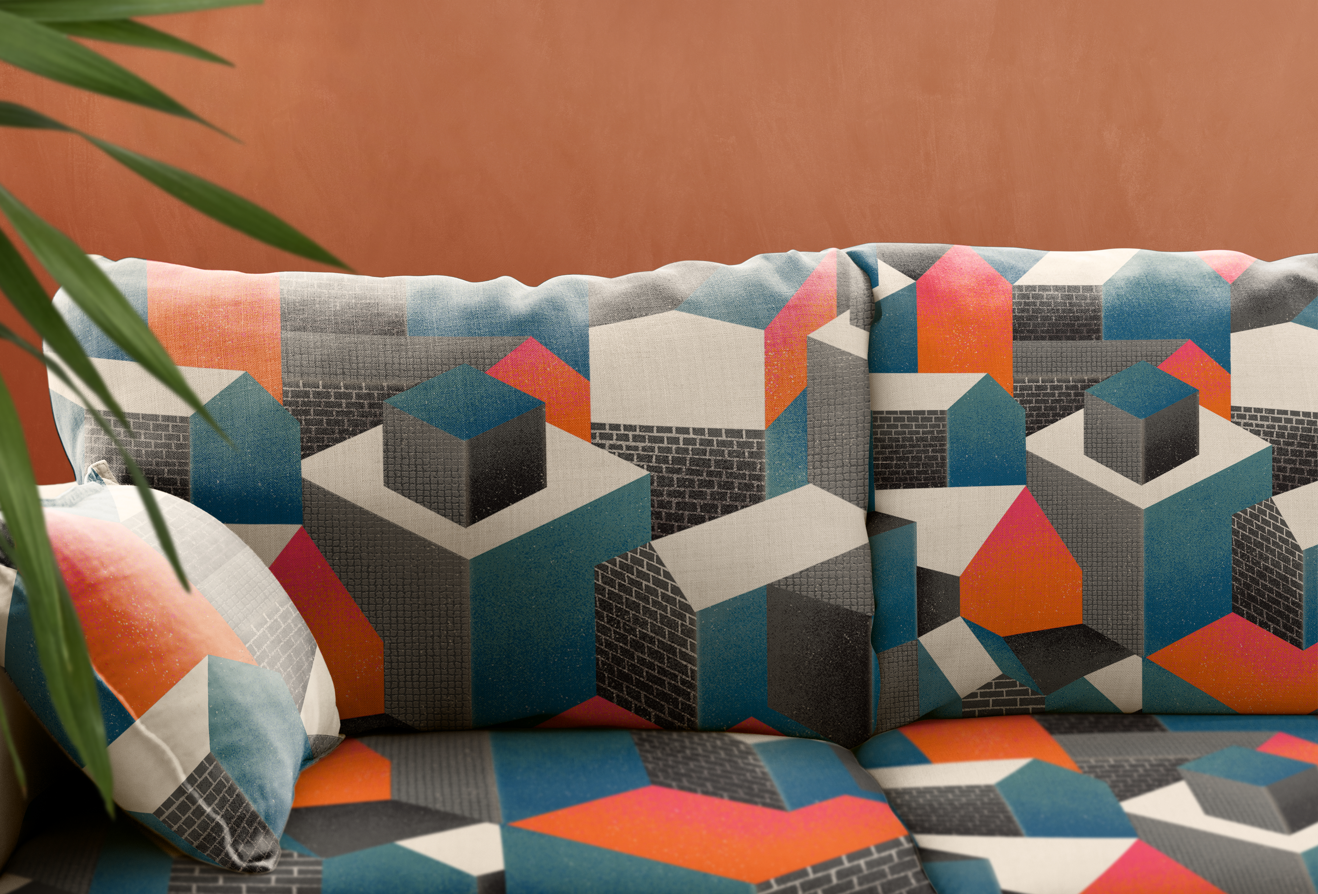 A couch with a colorful geometric pattern in blue, black, gray, and red.