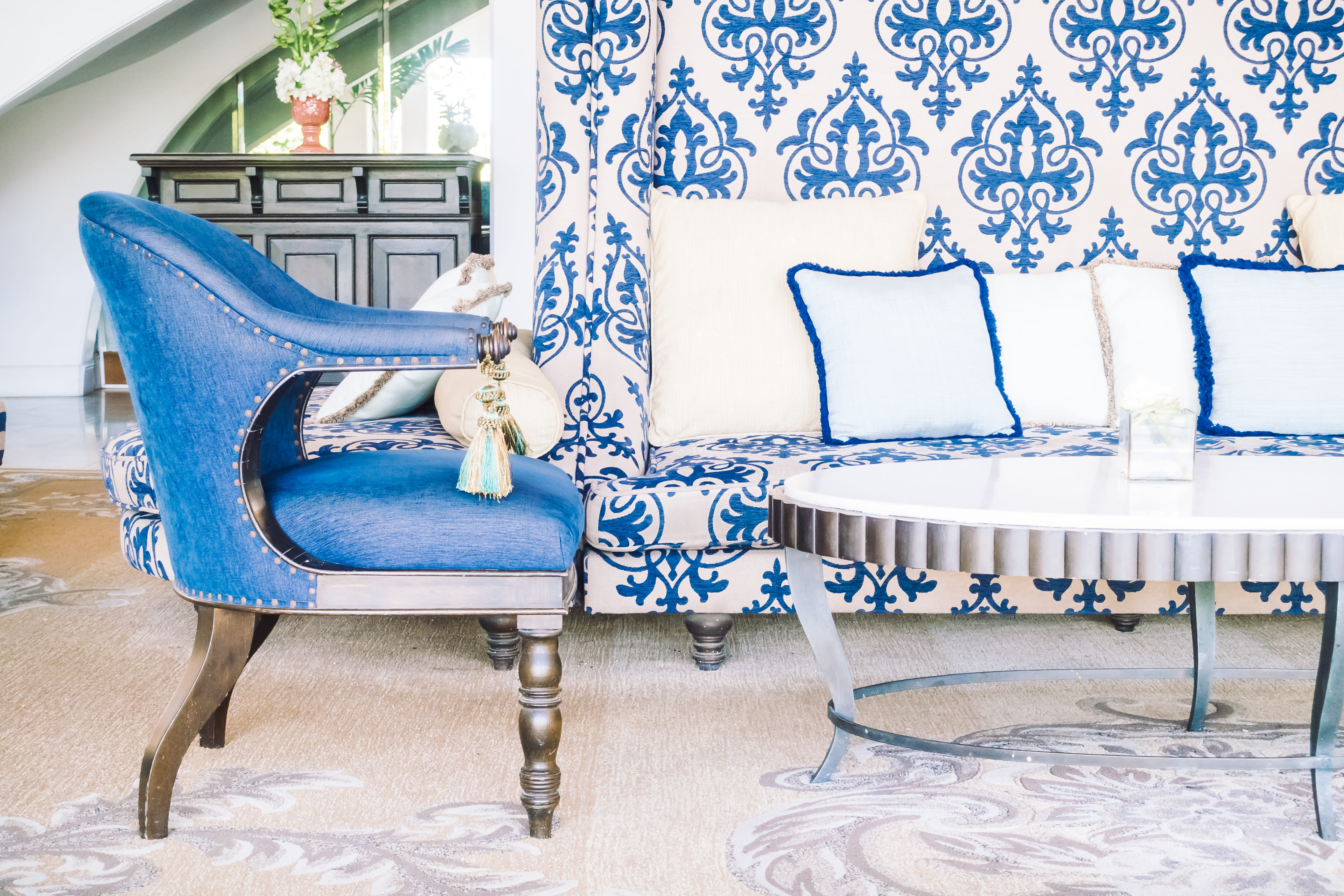A room with patterned furniture in blue colors.