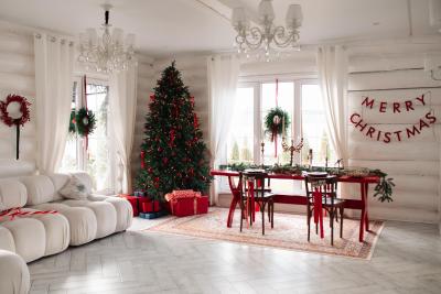 A living room decorated for Christmas in red and white.