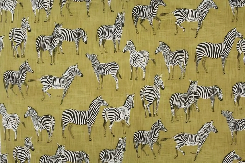 A vibrant yellow and black fabric featuring a pattern of zebras.
