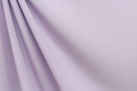A close-up of a solid-colored purple polyester fabric.