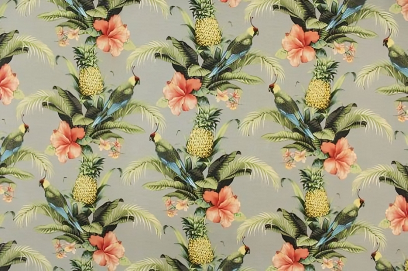 Tropical print fabric featuring vibrant pineapples and colorful flowers on a bright background.
