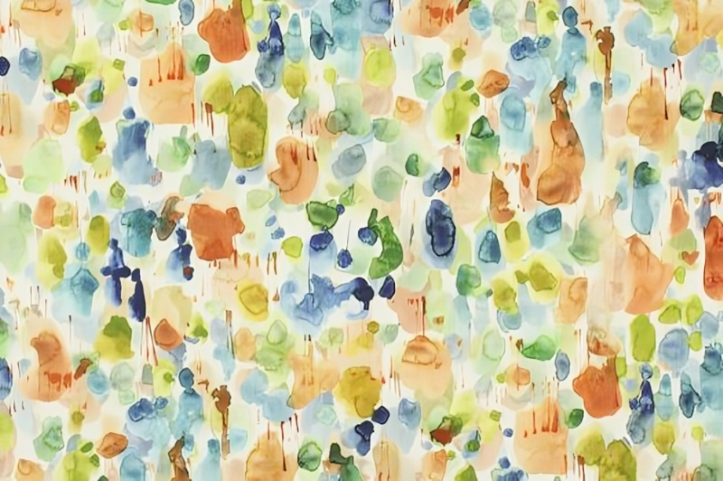 A vibrant watercolor print fabric featuring a blend of multiple colors in an artistic design.