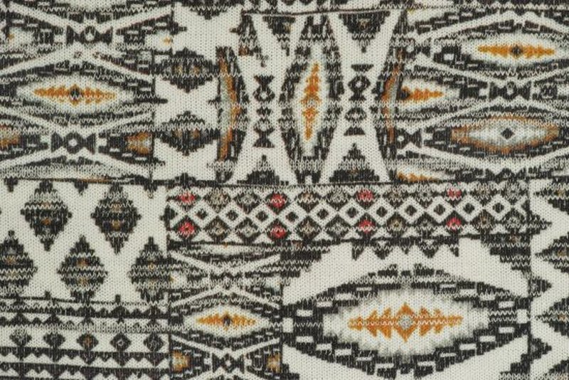 Black and white fabric displaying a tribal pattern with complex shapes and contrasting colors.