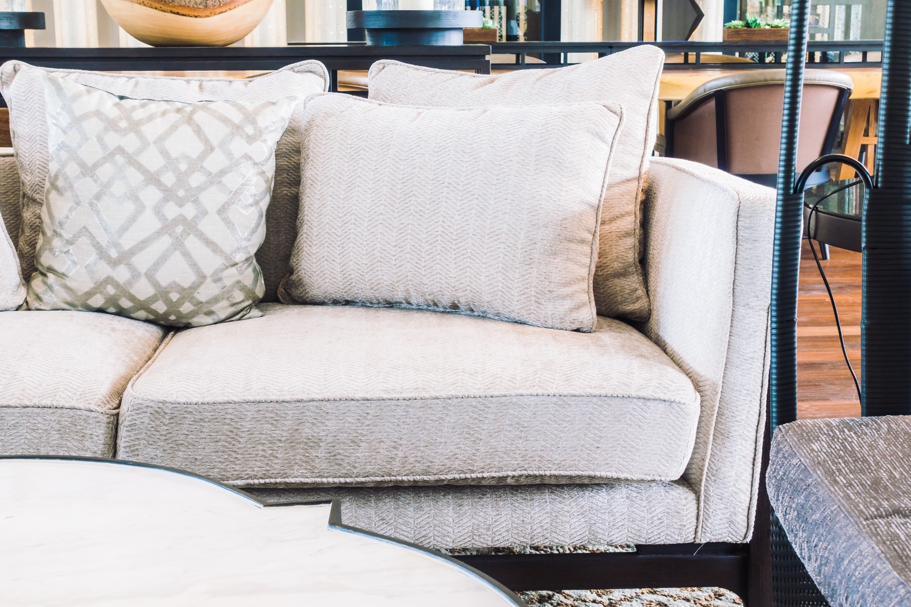 Light colored crypton fabric sofa with pillows.