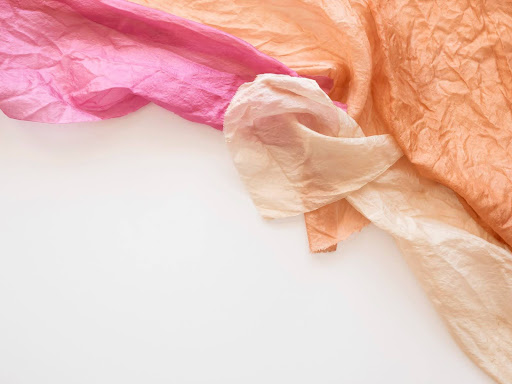Lightweight voile fabric with a smooth finish, in pink, orange and beige colors.